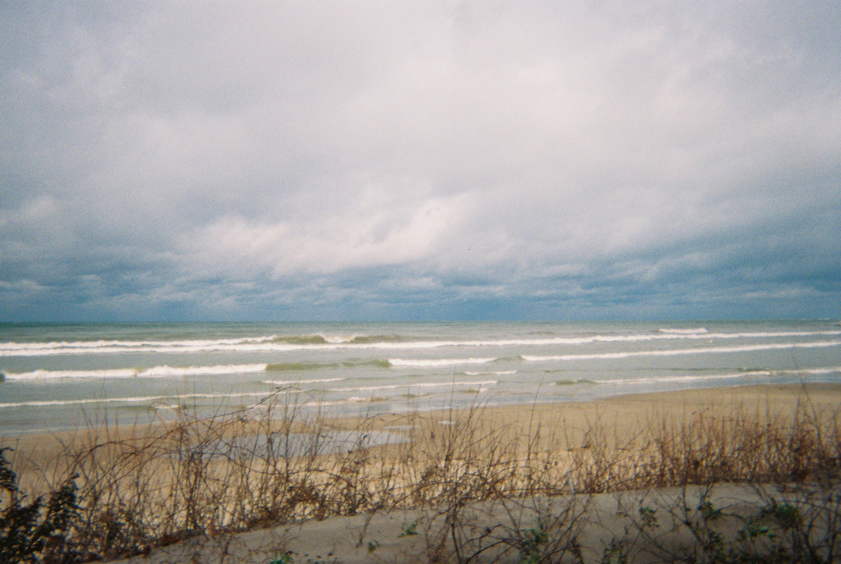 Great Lakes shoreline and surf under heavy clouds