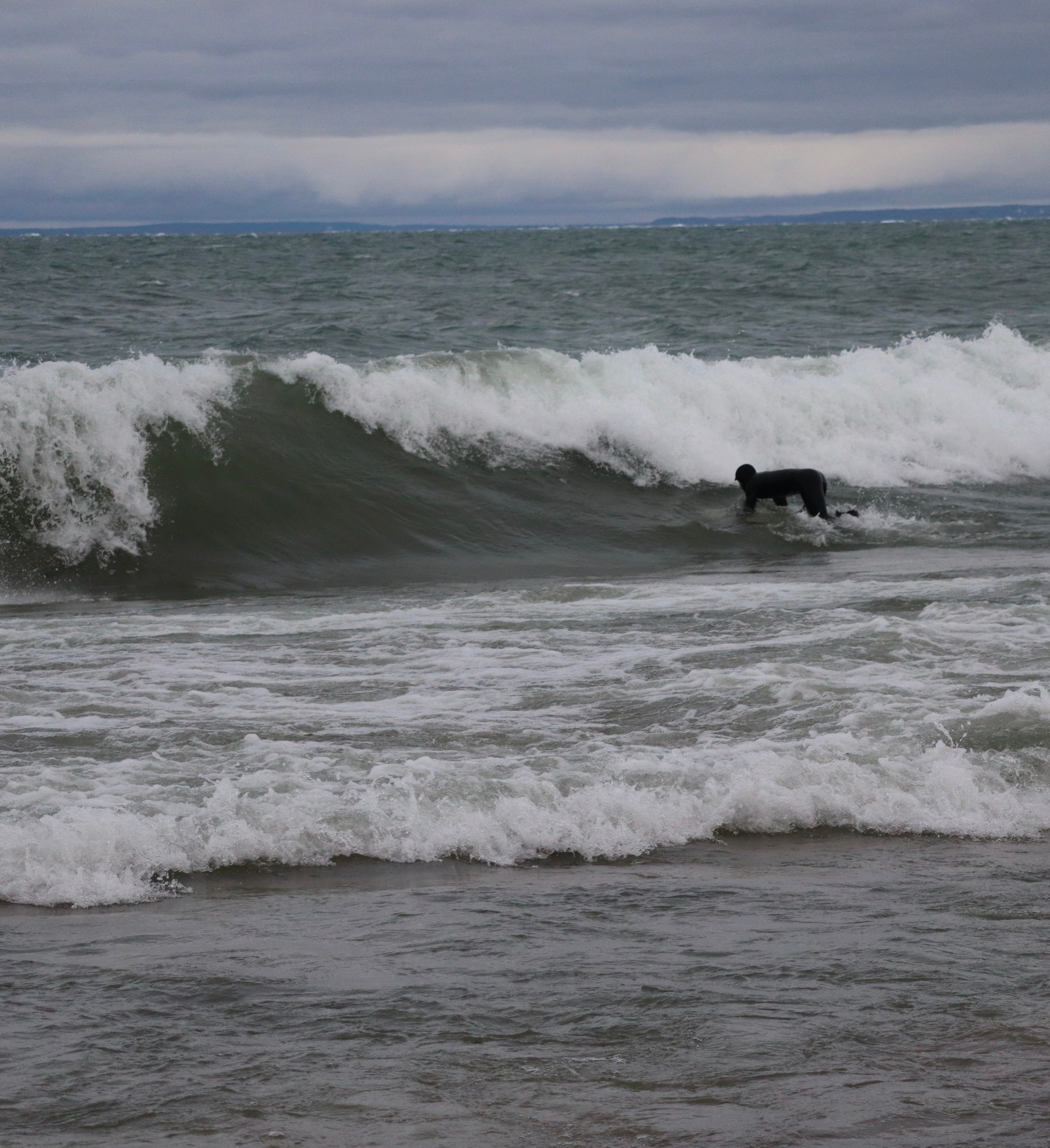 Surfer riding a wave in Great Lakes conditions